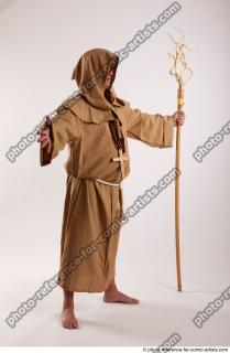 08 2019 01 JOEL ADAMSON MONK STANDING POSE WITH A…